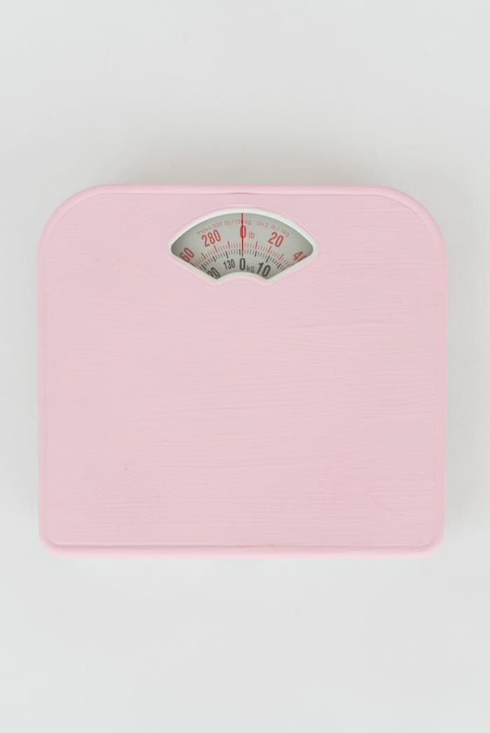 who-we-are Modern pink bathroom scale on white background, minimalist style.